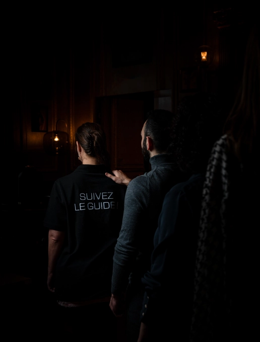 A single file of people heading towards the ‘Dans le Noir?’ dark room in Paris